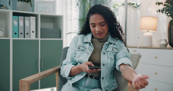 Phone, chemotherapy and woman on iv drip in clinic for cancer treatment, medication or healing. Medicine, infusion and female patient on tech for online research in hospital office for remission.