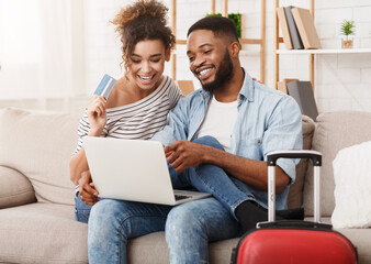 Preparation for travel. Romantic couple using laptop, booking hotel online