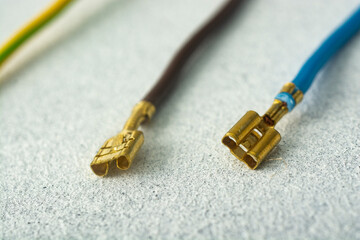 Ground wires with electrical terminals on a light background.