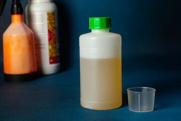 Closeup unlabeled bottle as mockup copy space for herbicide, fungicide or insecticide.