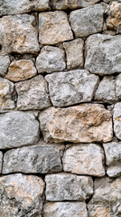 A wall made of large rocks with a gray and brown color
