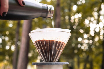 coffee filter in forest. Making coffee. Pouring water. Pouring coffee. Aroma. Reusable coffee cup....