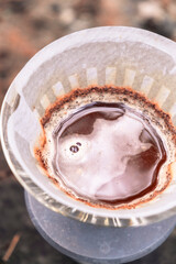 Coffee filter. Top view. Close-up. Foam on coffee. Coffee aroma. Trendy coffee in nature. Autumn atmosphere. Forest. Coffee on the road. Coffee in the forest