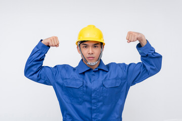 A serious worker flexes both arms, displaying determination and physical strength. Ideal for emphasizing power, work ethic, and dedication in blue-collar professions
