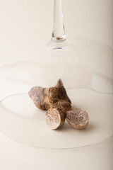 Fragrance of  white truffle mushrooms on a beige background. The smell of truffle is used in perfumery. Smell glass and autumn leave. Piedmont, Northern Italy, Spain and France