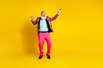 Photo of elegant positive crazy cool old man dressed stylish bright clothes dance empty space isolated on yellow color background