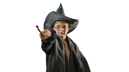 A wizard boy with a magic wand in a Halloween costume