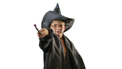 A wizard boy with a magic wand in a Halloween costume