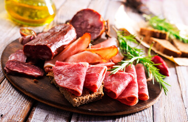 Different Italian ham and salami with herbs