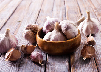 Garlic Cloves and Bulb in vintage wooden bowl.