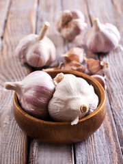 Garlic Cloves and Bulb in vintage wooden bowl.