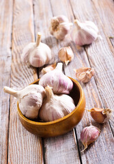 Garlic Cloves and Bulb in vintage wooden bowl.