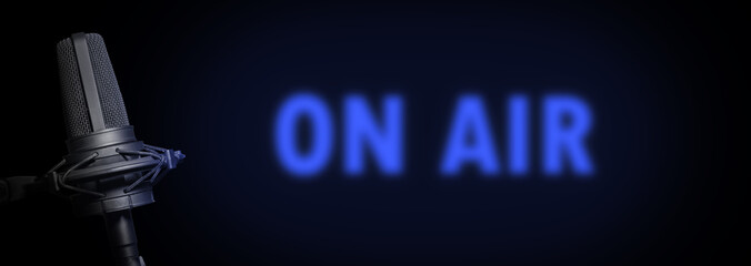 Broadcasting radio banner with vocal microphone and ON AIR neon light in the dark