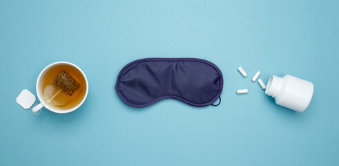 Sleep essentials eye mask, tea, pills. Concept of relaxation and rest, insomnia treatment