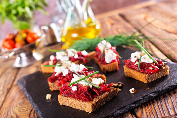 Baked beet on bread, with cheese and walnuts