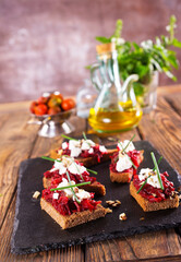 Baked beet on bread, with cheese and walnuts