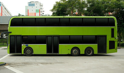Blank double decker bus for advertising mock up wrap display. Out of home OOH advertising on public transportation. Green bus. No people