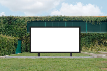 Mock up template: Horizontal billboard out of home (OOH) advertising poster on grass, against background of lush plant wall of building. Bright day, blue sky with clouds. Transparent png file