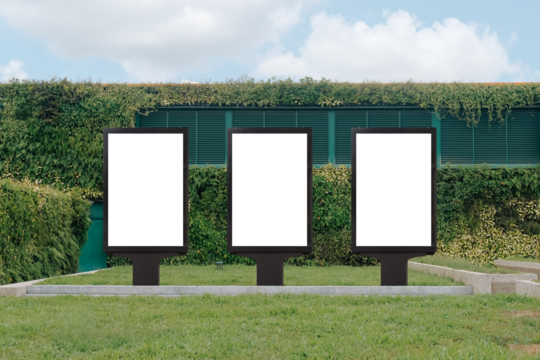 Vertical mock up template: 3 out of home (OOH) advertising billboard posters on grass, against background of lush plant wall of building. Bright day, blue sky with clouds. Transparent png file.