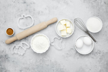 Ingredients for baking Halloween cookies including flour, butter, sugar, spices, eggs. Seasonal autumn baking