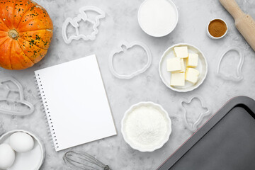 Ingredients for baking cookies for Halloween, notepad mock-up for writing down the recipe. Seasonal autumn baking