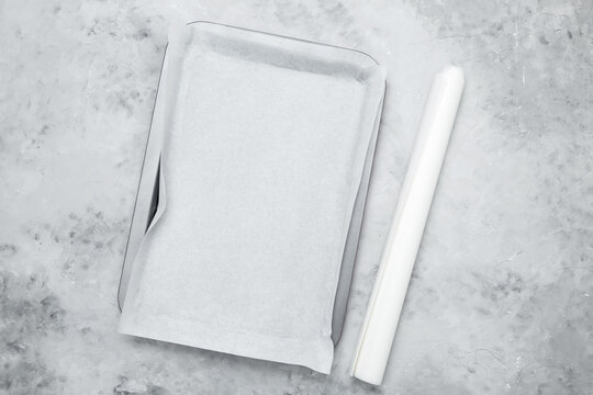 Empty baking tray covered with baking paper
