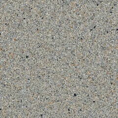A close-up view of a concrete surface with small rocks scattered on it