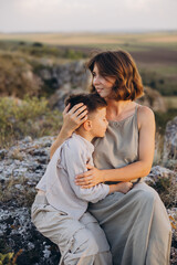 Mother and Son Embracing Outdoors in Nature During a Warm, Peaceful Day