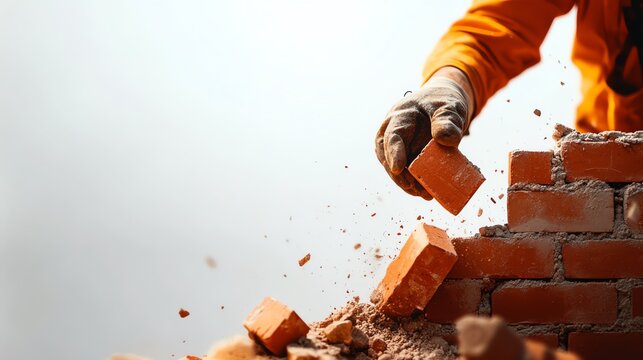 A close-up of a construction worker laying bricks, showcasing skillful craftsmanship and focus in masonry work.