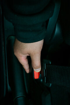 Close-up of a person fastening the car seat belt