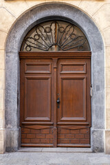Elegant wooden door with ornate glass design in a historical building in old town