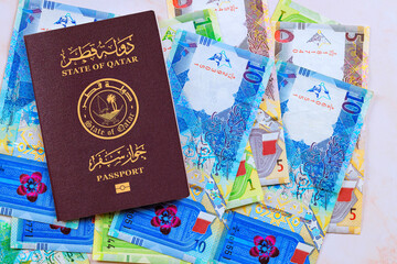 Passport issued by State of Qatar with Qatari banknotes in currency Riyals in cash of various denominations