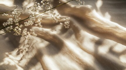 Naklejka premium Aesthetic boho wedding textile background, draped neutral beige linen fabric texture with an absrtact floral sunlight shadows