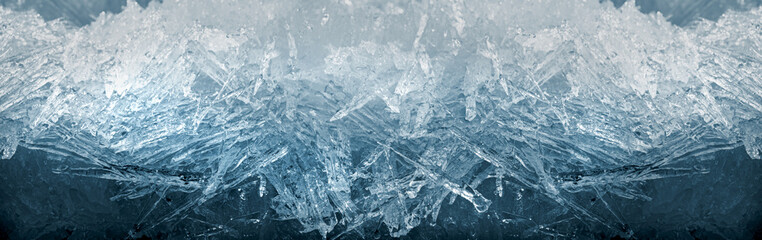 Winter snowy banner, frozen background. A scattering of large long ice crystals in the form of needles on the river in winter. Dark and Light