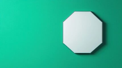 A white octagon mirror is hanging on a green wall