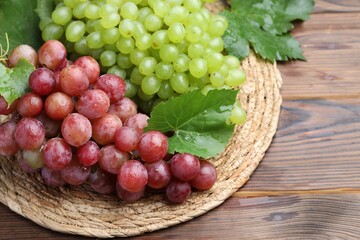 Delicious fresh ripe grapes on wooden table