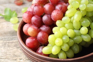 Fresh ripe grapes on wooden table, closeup