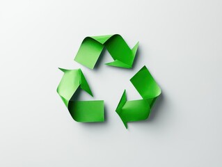 Obraz premium Flatlay of a minimalist green recycle symbol made from paper, surrounded by white space, eco-friendly concept