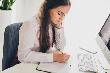 Photo portrait of teen cute daughter computer online do homework wear uniform remote education home schooling isolated indoors background