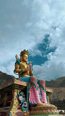 Giant Maitreya Buddha Statue Against a Dramatic Sky