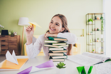 Photo portrait of cute adorable teen girl playful have fun paper plane wear uniform remote lesson education from home indoors