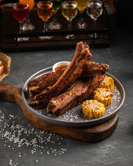 Portion of grilled german traditional pork ribs with corn