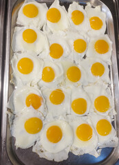 Concept of food All-inclusive buffet-style in Turkey. A place with a lot of fried eggs, scrambled eggs. Vertical orientation. Selective focus.