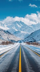Naklejka premium Straight Road Leading to Snowy Mountains Under Clear Blue Skies