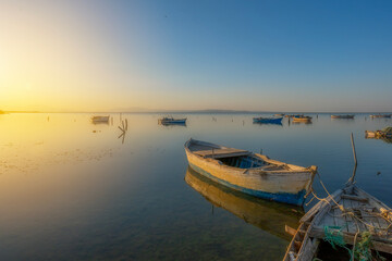 Obraz premium Fishing boats in the Karina region near the Söke district of Aydın province Turkey are heated by sunlight at sunrise