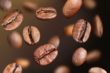 Coffee beans fly in the air on a dark background. Coffee beans background.