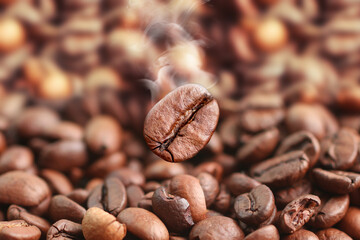 Fototapeta premium Coffee beans close-up with smoke. Roasted coffee beans.