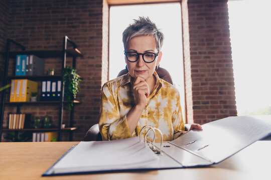 Photo of pretty senior female read report minded folder wear formalwear coworking successful nice light office