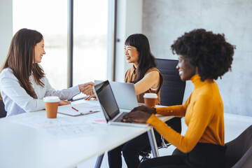 Diverse Group of Women Collaborating in Modern Office Environment