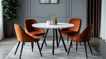 A round dining table with black metal legs and a white top, surrounded by four brown chairs on a gray carpet in front of a gray wall with a window. 